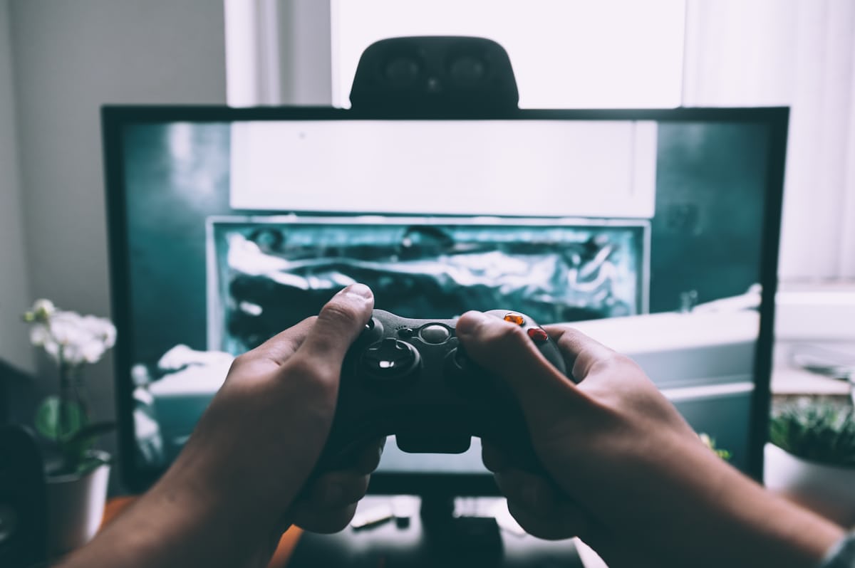 Friends playing video games on a sofa